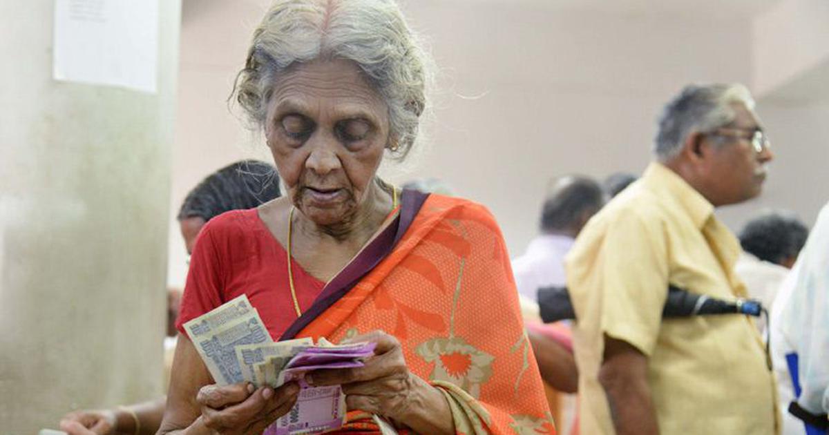 A old women count the notes of indian rupee of old age pension scheme
